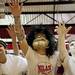 Milan junior Jake Friese and other costumed students gesture during a free throw on Friday. Daniel Brenner I AnnArbor.com